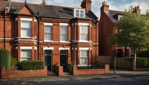 A mid-terrace two-storey brick house on a residential street, illustrative image
