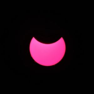 A partial solar eclipse, the Sun reduced to a bright crescent behind the Moon