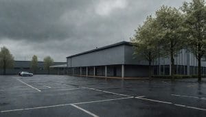 An empty car park in front of a generic modern leisure centre building on a cloudy day