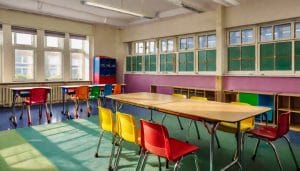 A bright modern primary school classroom with colourful resources and natural light, illustrating inclusive education settings