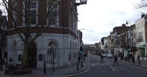 Maidstone Town Hall on the High Street, with its clock, looking down the High Street