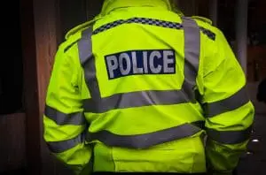 Police officer in hi-vis jacket from behind