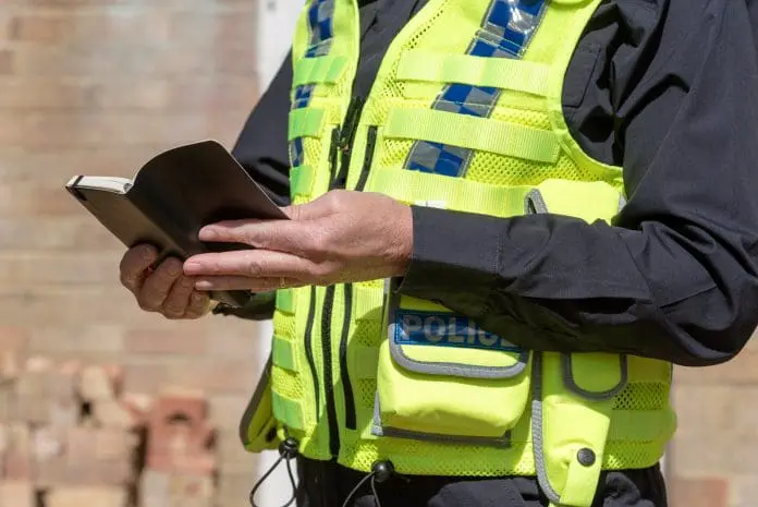 Close,Up,View,Of,A,Woman,Police,Officer,Holding,An