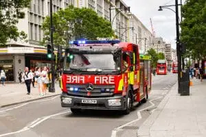 Fire engine with blue lights on street